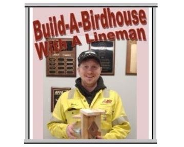 Lineman holding reused meter birdhouse creation for Spring 2020 Build-A-Birdhouse event.